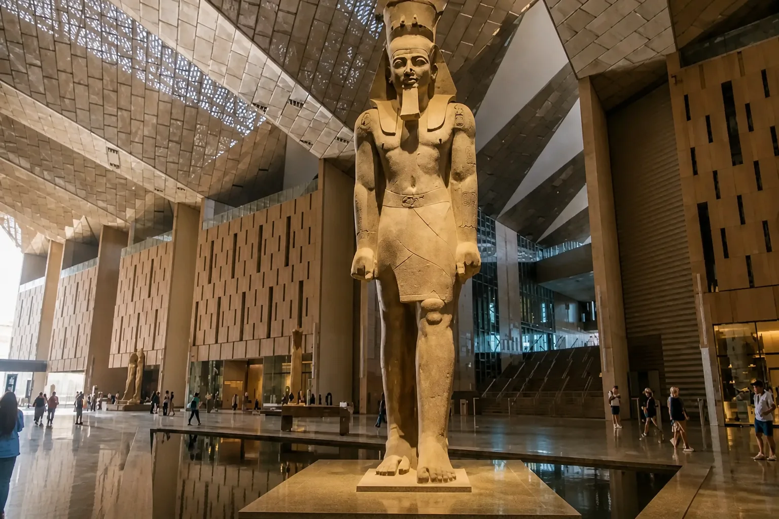 The grand staircase of the Grand Egyptian Museum framing the Pyramids